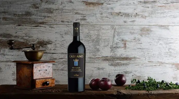 Vintage Wines You Must Have Casisano Brunello di Montalcino displayed alongside rustic elements, reflecting the wine’s deep Tuscan heritage and refined complexity.