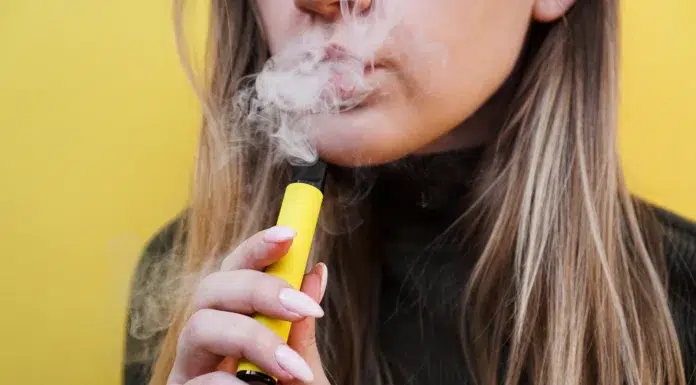 Is Vaping Really A Fashionable Smoking Alternative? a young woman vaping