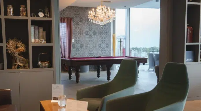 The Best Tips For Lighting Every Room Of Your House chairs with illuminated gorgeous chandelier over snooker table at home. Photo via vecteezy