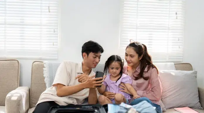 Modern Family Vacation with Smartphone Luggage preparing for their family-vacation bringing their essential and a smart phone