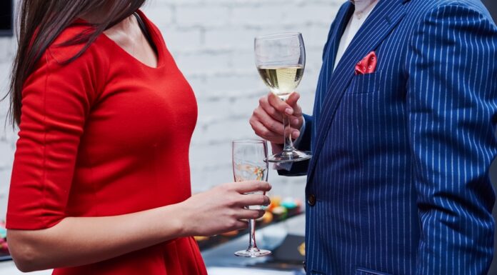 How to Look Best for a Formal Event man and woman with glasses of wine at a formal event