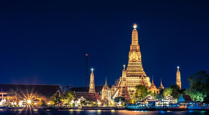 Bangkok Luxury Travel Guide And Top Six Things To Do Night time view of Wat Arun (Temple) across Chao Phraya River in Bangkok, Thailand.
