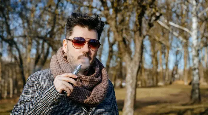 Vaping and Its Influence on Modern Fashion Trends confident young bearded male in sunglasses vaping. Photo via vecteezy
