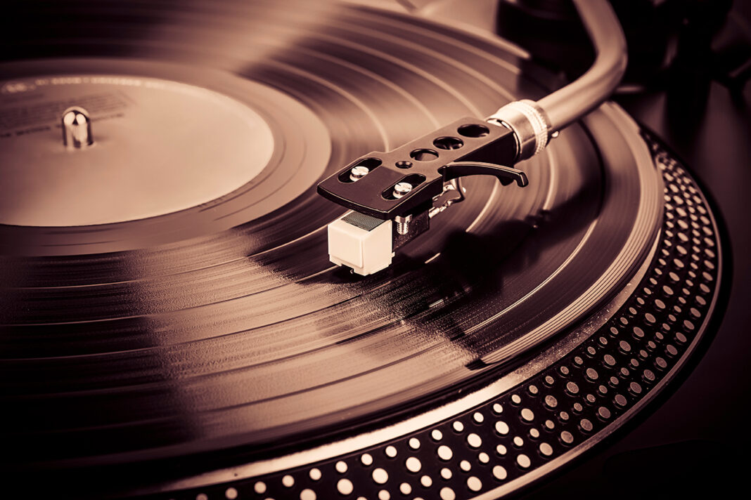 A needle on a turntable that plays music