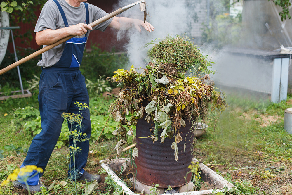 man firing grass in the garden