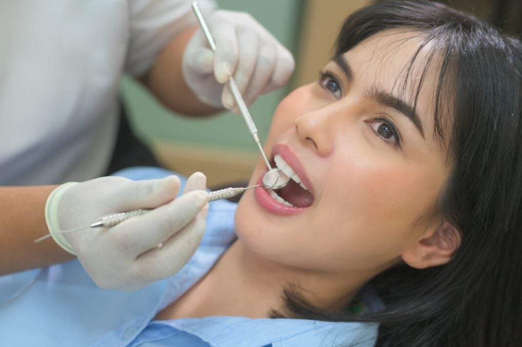 Dentist working on his-her patient. Unsplash