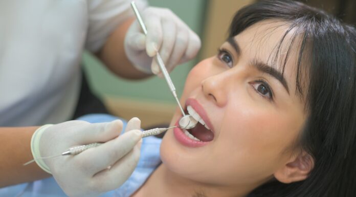 Why It’s Important To Go To Your Dentist For Regular Checkups Dentist working on his-her patient. Unsplash