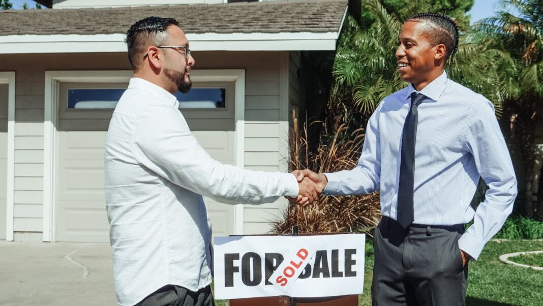 Real Estate Agent with his customer. Photo via Pexels by Kindelmedia