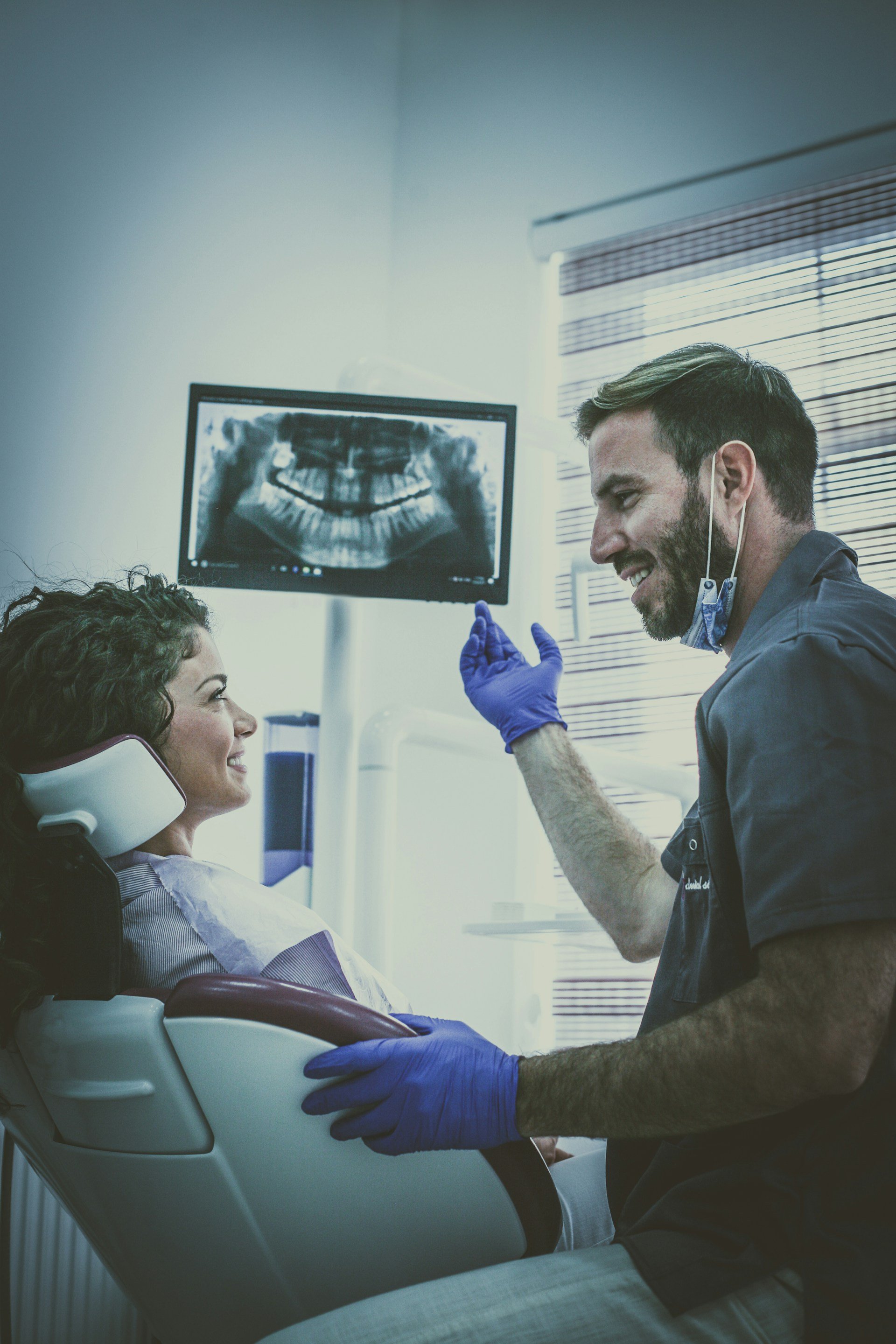 dentist showing xray to his patient. Unsplash