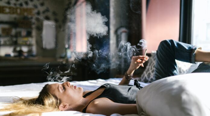 How Can Using Cannabis Products Improve The Quality Of Your Sleep woman consuming cannabis product