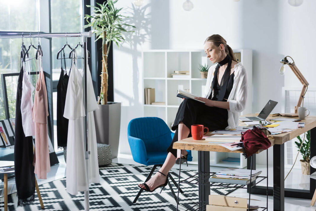 fashion designer reading a book that inspires her