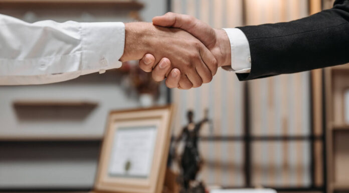 How to Prepare for Your Initial Consultation with a Lawyer lawyers shaking hands with a client