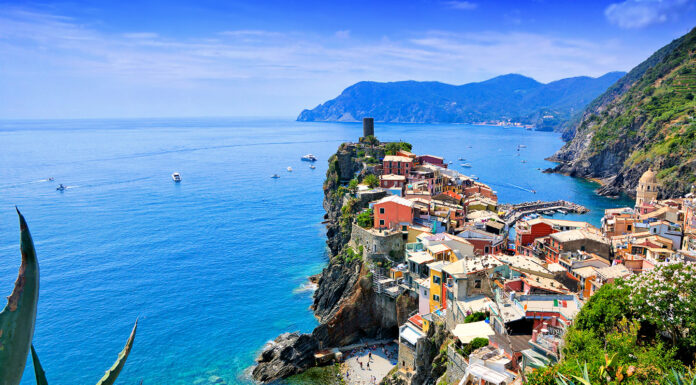 Exploring Italy’s Most Luxurious Regions Beautiful Cinque Terre village of Vernazza, Italy. Aerial view. By Jenifoto