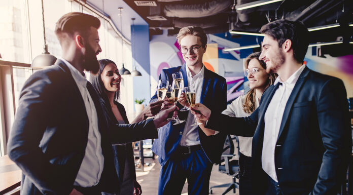 Beginner’s Guide to Corporate Event Styling Group of young business people are working together in modern office. Successful team in coworking are celebrating a corporate event with champagne. Freelancers.
