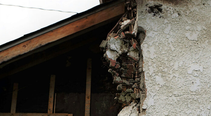 The Link Between Asbestos Exposure and Lung Cancer: What You Should Know Asbestos shown on a house wall. Photo by Tneil Abt via Unsplash