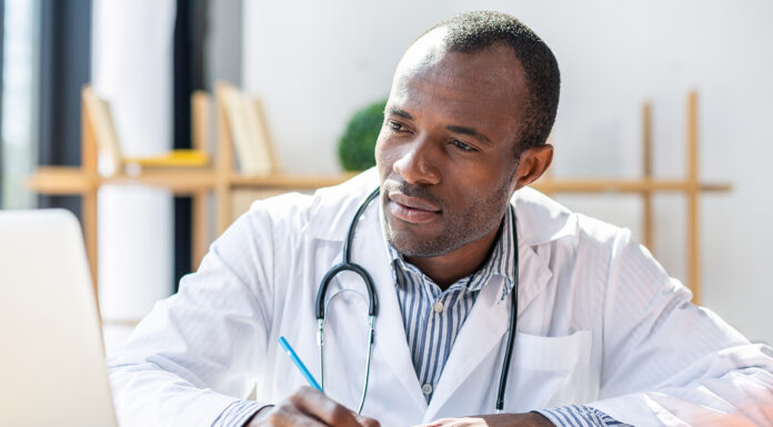 How to Qualify for a Physician Mortgage: A Step-by-Step Guide Physician filling out a report on his computer. Photo courtesy of Adobe Free stock images