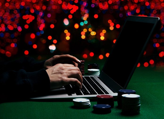 Playing online poker. Photo via Adobe Stock Free Images