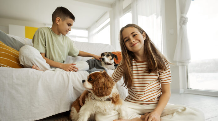 How to Clean Your Home Thoroughly Without Causing Any Harm to Kids or Pets: 8 Ideas cousins-spending-time-together-home-with-pet-dog. Photo via Freepik free