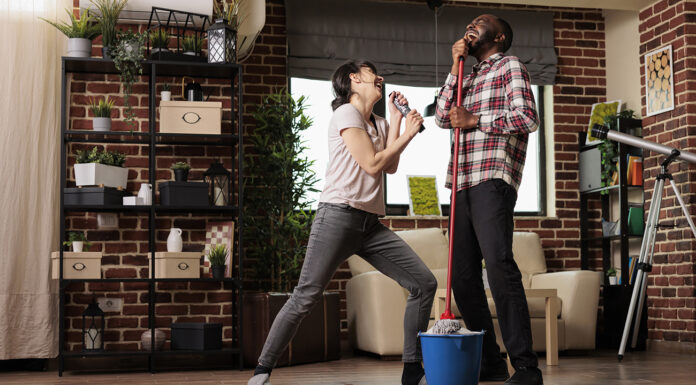 Why a Stick Vacuum Could Be Your Next Best Cleaning Partner Happy multiracial couple singing with emotion. Photo courtesy of WhitePress.com