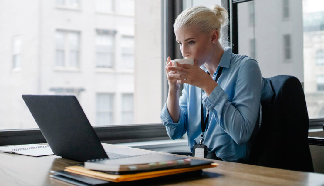 A woman drinking coffee and optimizing her work-life balance. Photo by Sora Shimazaki via pexels