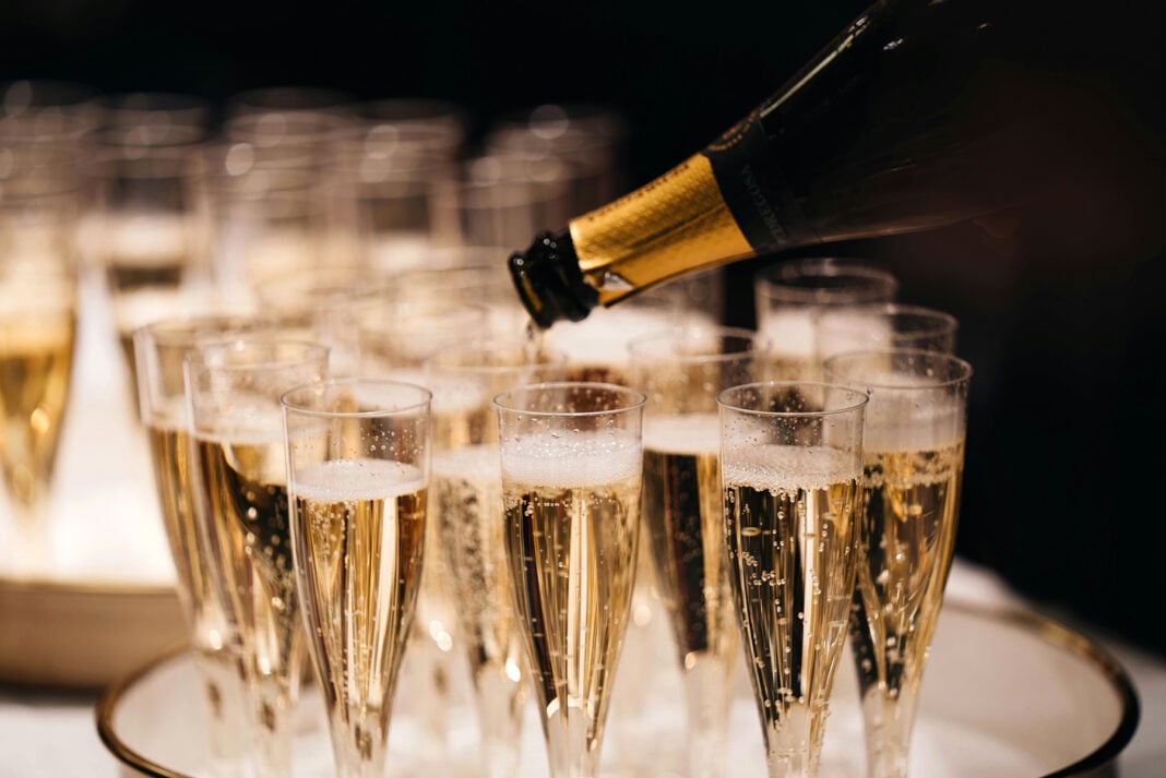Champagne glasses filled. Photo by Alexander Naglestad via unsplash