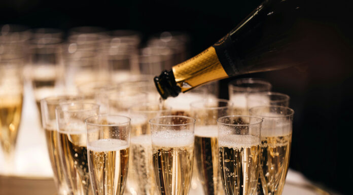 Expert Tips For Serving Champagne with Berry Brothers Berry Bros. & Rudd Champagne glasses filled. Photo by Alexander Naglestad via unsplash