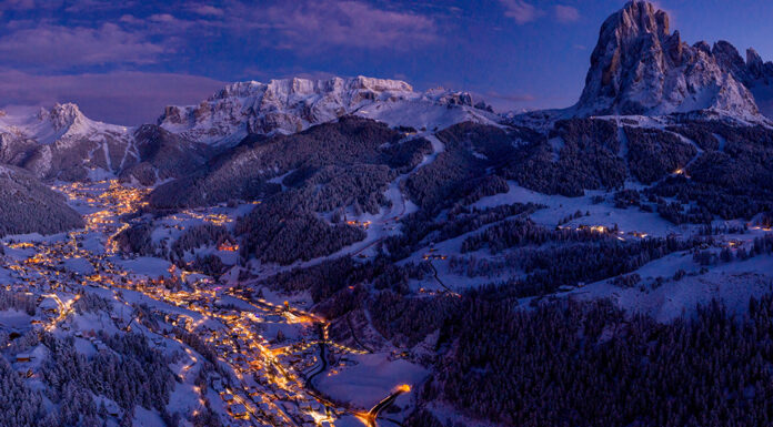 Discover Some of the Most Exclusive Ski Resorts in the World Beautiful panoramic view of Dolomites mountains at dusk during w