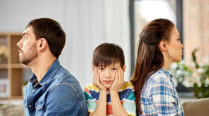 Facing Divorce: How To Cope Well When Kids Are Involved A couple getting a divorce with a child. Photo by adobe free stock images