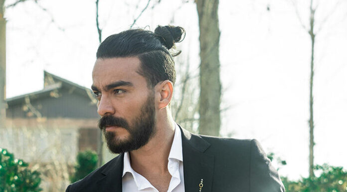 How to Dress Up and Dress Down Buttoned Shirts Men wearing a button down white shirt. Photo by Emre Keshavarz via pexels