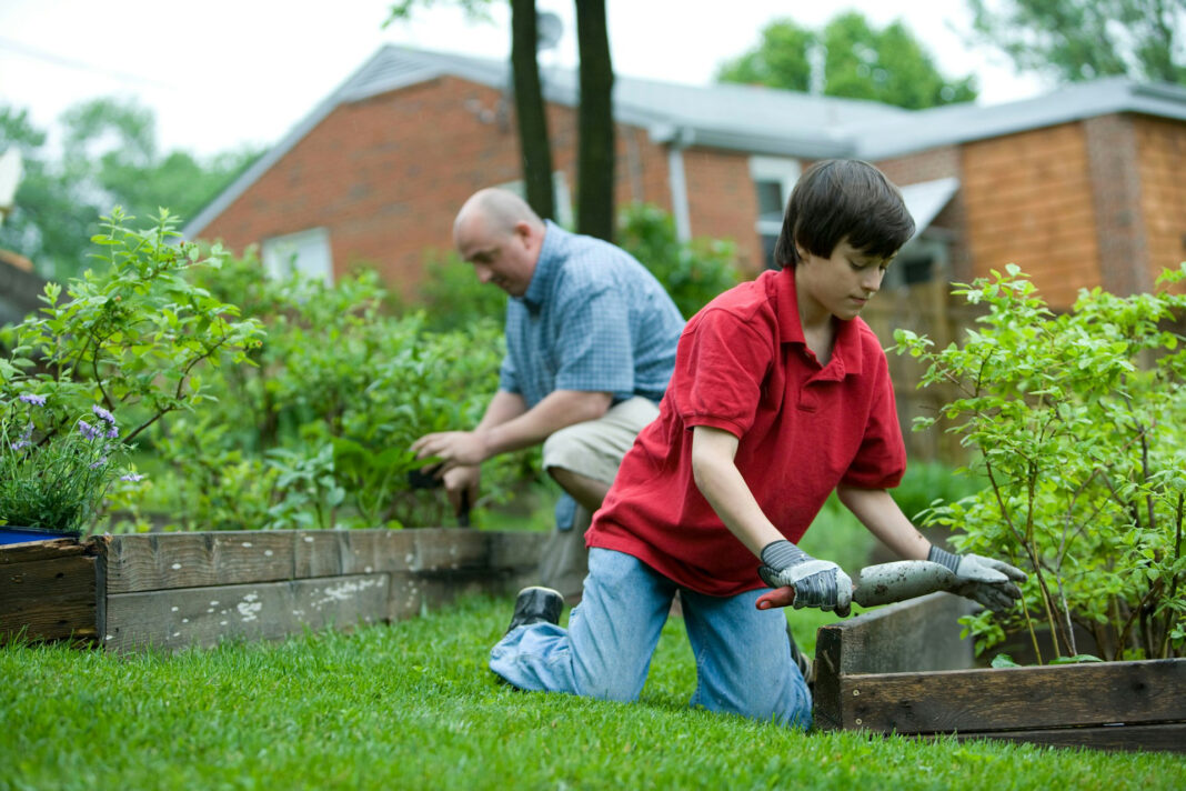 family together working in the yard. Photo by CDC via unsplash