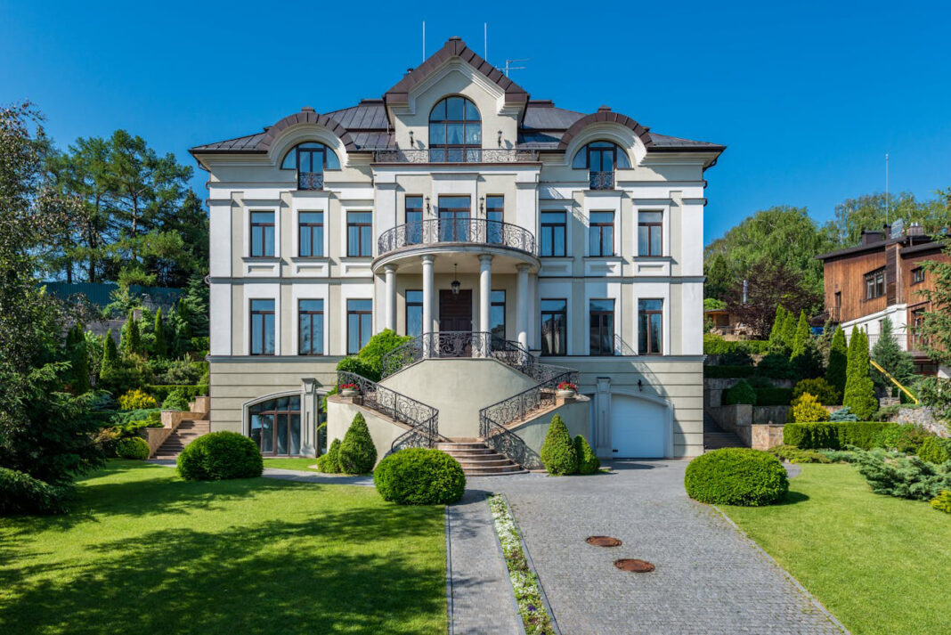 A beautiful and big house with metal roof. Photo by Max Vakhtbovycn via pexels