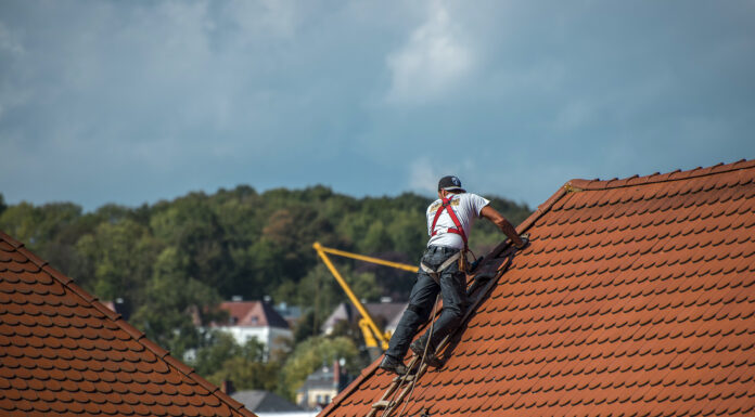 How to Find Proper Roofing Services: A Full Guide Roofer on top the roof of a house. Photo via pixabay