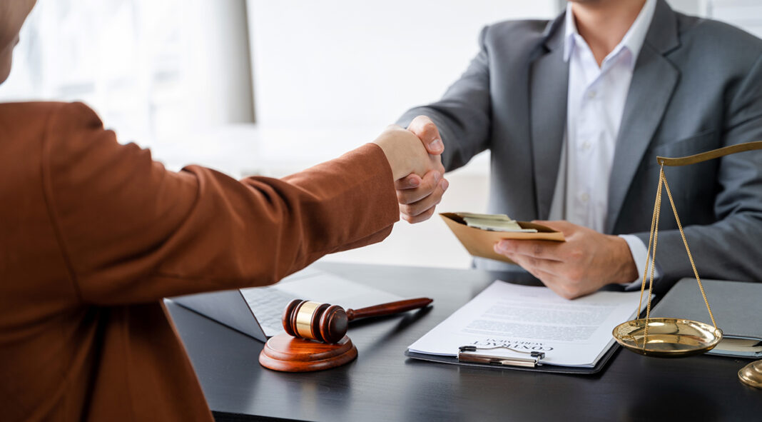 partner lawyers attorneys shaking hands after discussing a contr
