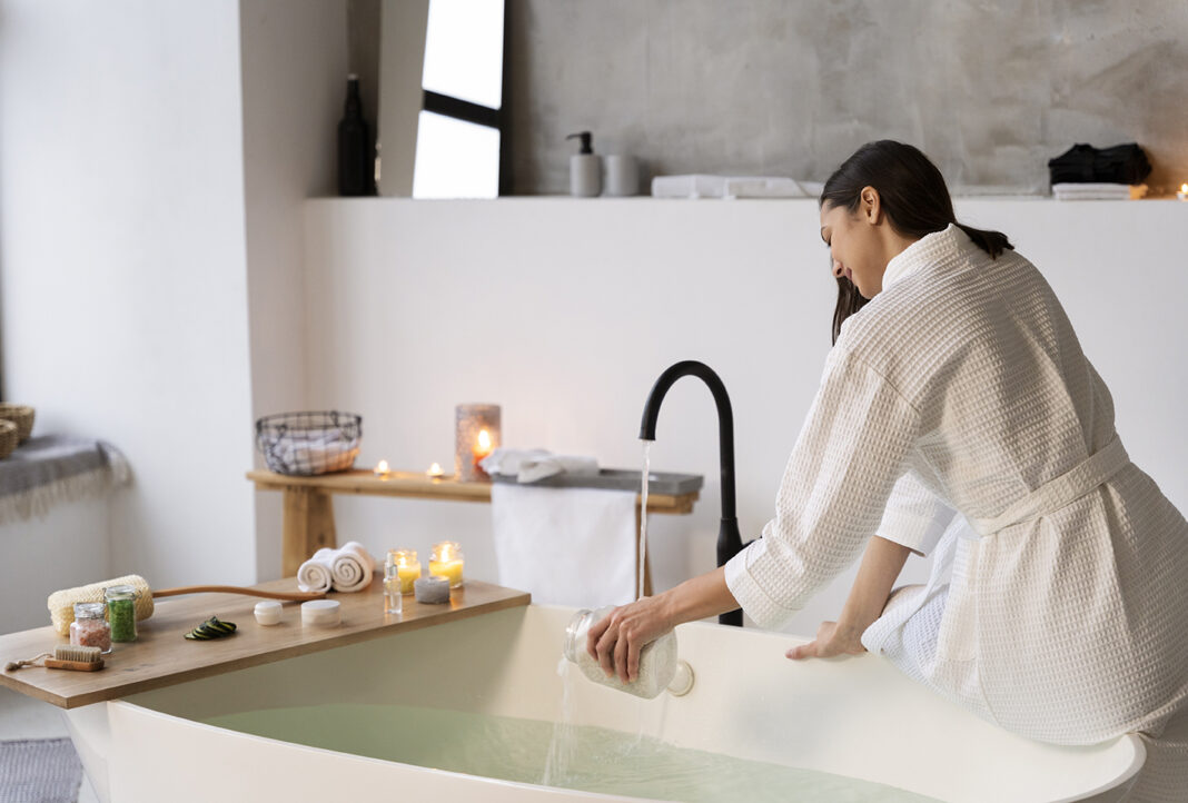 Young woman taking a bath in her bathroom like spa. Photo by freepix