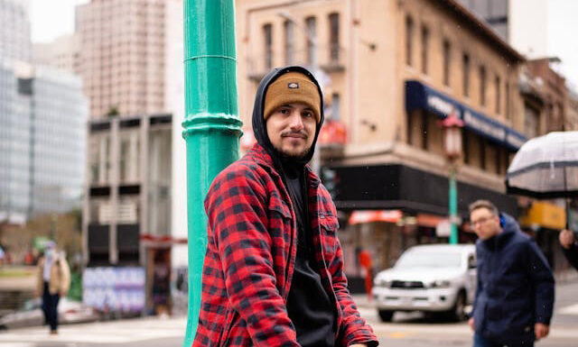 Flannel & Hoodie: The Ultimate Fall Layering Combo for Men Men wearing a flannel shirt with a hoodie. Photo by Marcus Silva via pexels