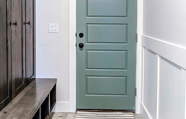 Significance of a Hallway Runner in a Home with Kids Hallway with runner rug on the floor that leads to the fire door of a home