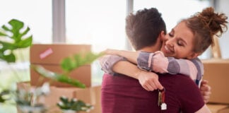 A Couple happy and able to create a budgeting plan. Photo via freepik from gpointstudio