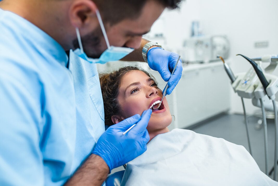 A Woman is receiving dental treatment services. Photo via adobe free stock images