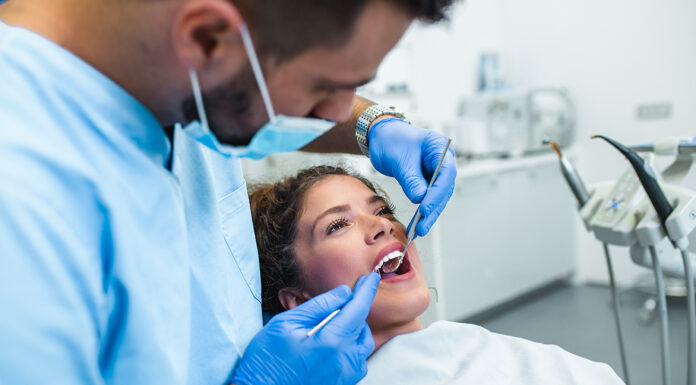 Reasons Why You Should Never Let Cost Stop You From Having Dental Treatment A Woman is receiving dental treatment services. Photo via adobe free stock images