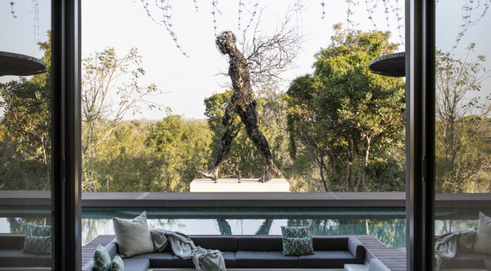 Shiviko Kruger, An Immersion in Nature, Luxury, and African Heritage A sculpture entitled ‘Twigs’ forms a striking focal point next to the pool. Photo courtesy of Akara Design Studio