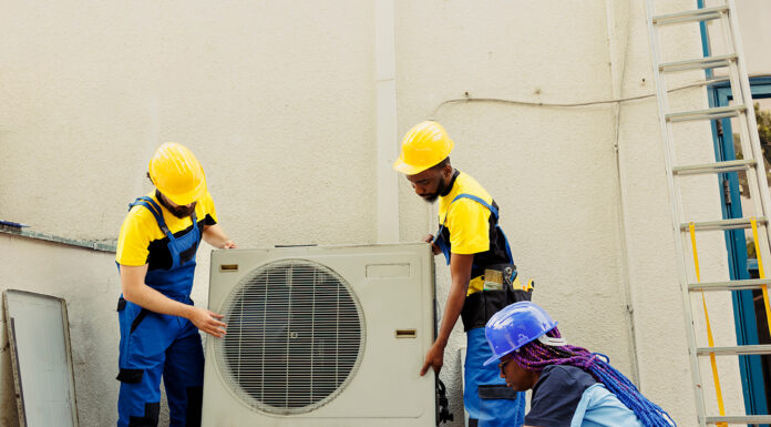 Common Air Conditioning Problems That Affect Luxury Home Comfort Air Conditioning problems getting fix by technicians. Photo by DC Studio via adobe stock