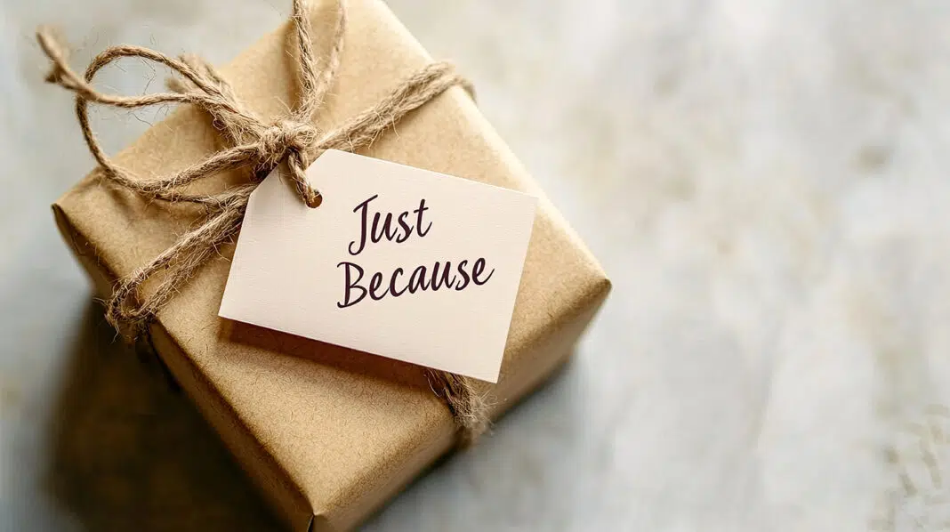 A small wrapped gift with a tag reading "Just Because" on a neutral background, with space for World Kindness Day messages. Photo source Adobe free Stock