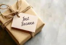 A small wrapped gift with a tag reading "Just Because" on a neutral background, with space for World Kindness Day messages. Photo source Adobe free Stock