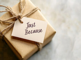 A small wrapped gift with a tag reading "Just Because" on a neutral background, with space for World Kindness Day messages. Photo source Adobe free Stock