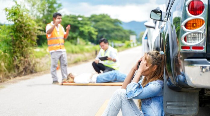 How Accidents Can Change Daily Life and Independence a young woman sits crying next to the car she crashed causing an accident