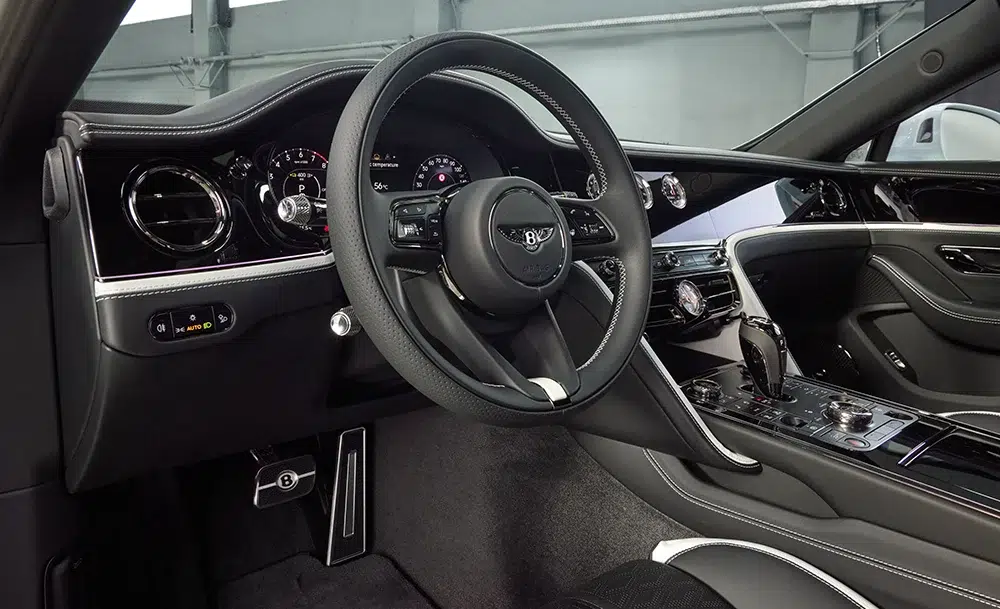 Driver’s view of the Bentley Flying Spur Speed interior showcasing black-and-white contrast stitching and instrument precision, echoing Steinway’s design purity. Driver’s view of the Bentley Flying Spur Speed interior showcasing black-and-white contrast stitching and instrument precision, echoing Steinway’s design purity.