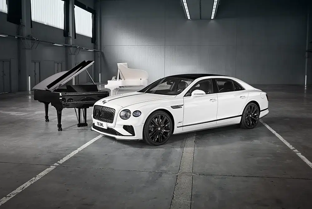 The Bentley Flying Spur Speed with Steinway’s monochrome grand pianos in a minimalist warehouse — a visual duet of engineering precision and musical artistry. The Bentley Flying Spur Speed with Steinway’s monochrome grand pianos in a minimalist warehouse — a visual duet of engineering precision and musical artistry.