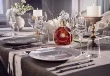 The Elite Pour: Inside Luxury Spirits & Fine Wines Louis XIII Cognac displayed on an elegantly set fine-dining table with crystal glassware.