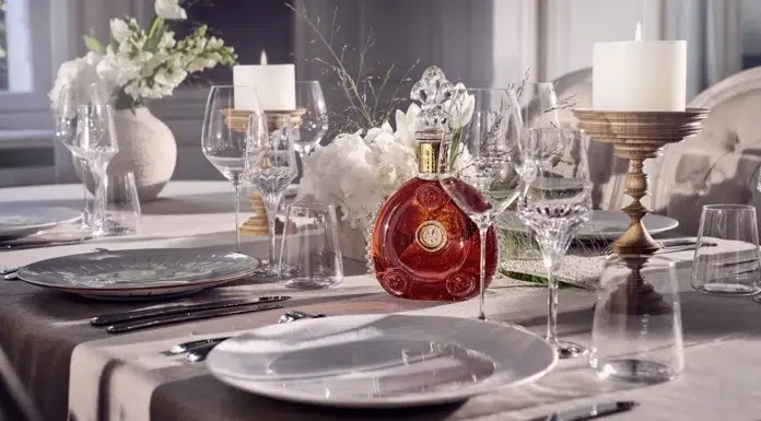 The Elite Pour: Inside Luxury Spirits & Fine Wines Louis XIII Cognac displayed on an elegantly set fine-dining table with crystal glassware.