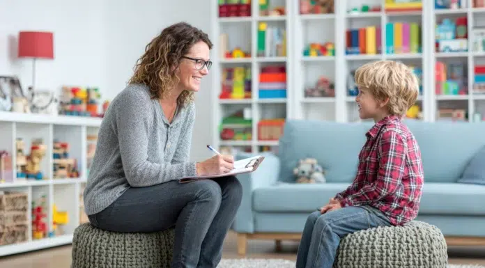 A Guide to Understanding Child Counseling Services A doctor wearing glasses is engaging in a conversation with a young child offering couseling services. Photo via vecteezy